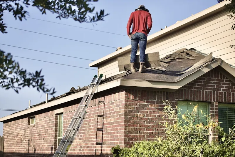 Professional roofer working on a residential roof in Stanley-Aley